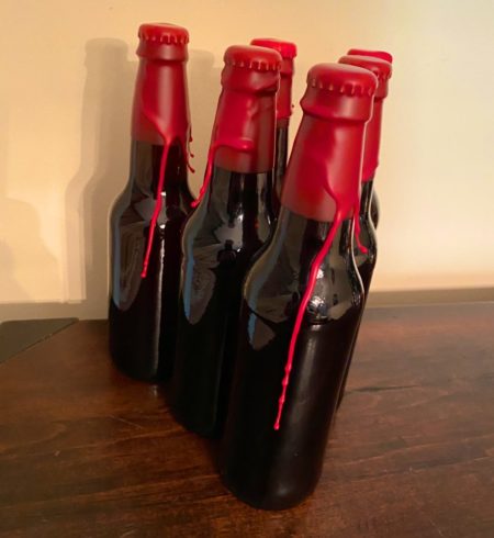 Bottles of home brew with waxed caps